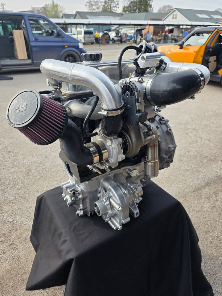 BagSport rear-mount turbo kit on an A-series engine, turbo side three-quarter view